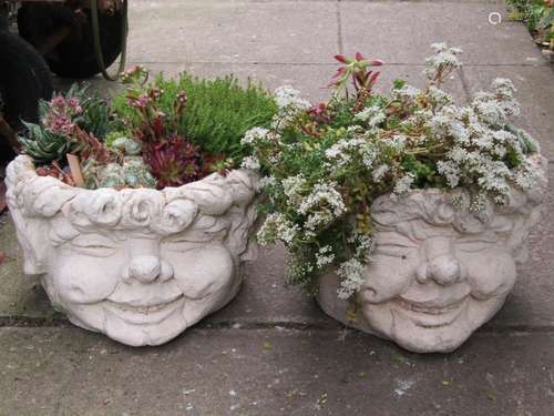 A pair of novelty comical head cast composition stone garden...