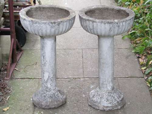 A pair of painted and weathered cast composition stone garde...