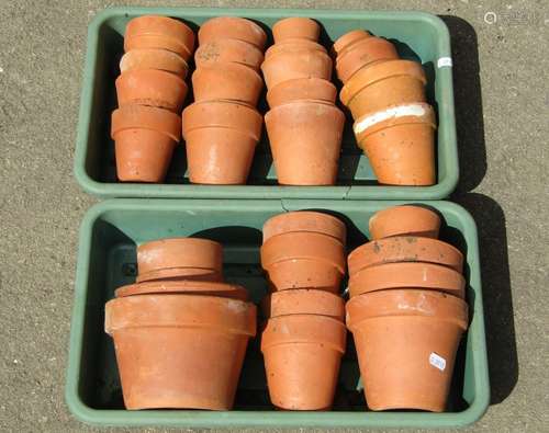 Forty small terracotta flower pots of varying size, the larg...