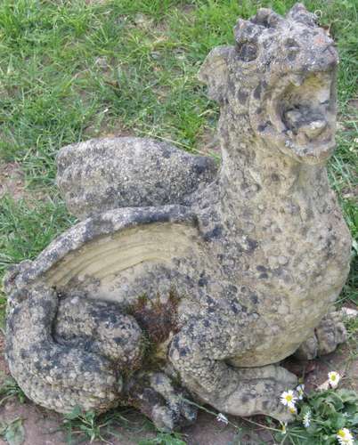 A weathered cast composition stone garden ornament in the fo...