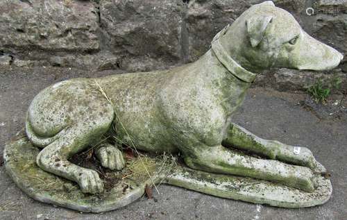 A weathered cast composition stone garden ornament in the fo...