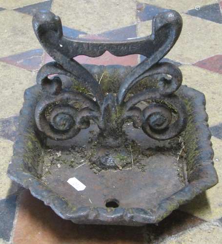 A 19th century cast iron boot scraper with scrolling foliate...