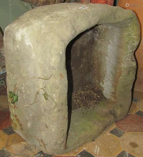 A weathered natural stone thick walled trough of square form...