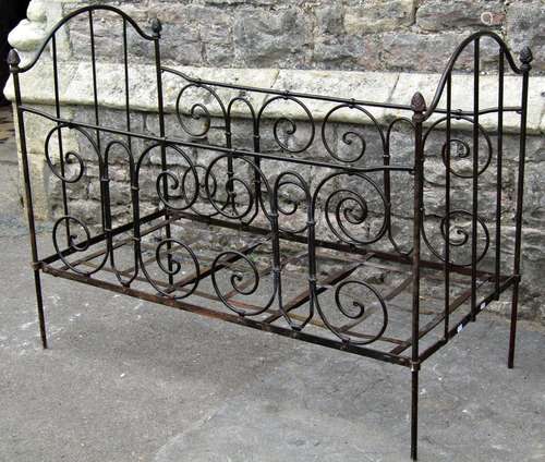 A Victorian green painted cast iron single bedstead with tub...