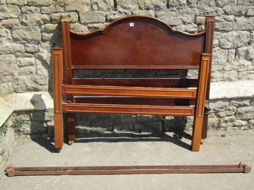 An Edwardian mahogany four foot bedstead with carved and mou...