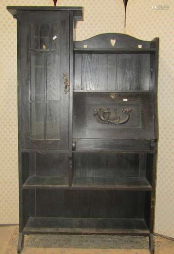 An Arts & crafts dark stained oak slender freestanding b...