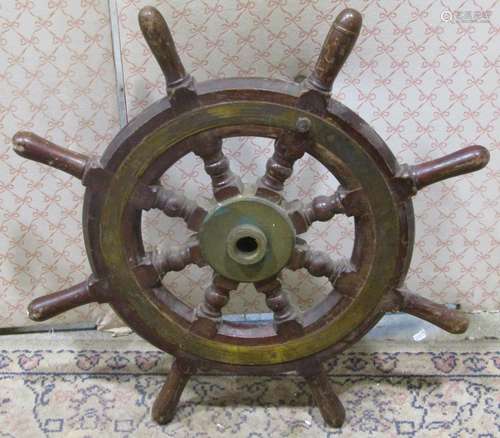 A marine ships wheel in teak with brass mounts, 60 cm maximu...