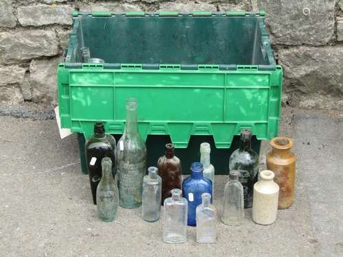 A crate containing a quantity of old bottles, some excavated