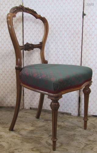 A set of four Victorian walnut balloon back dining chairs wi...