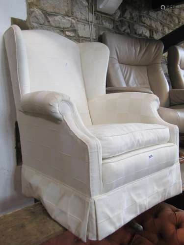 Contemporary wing chair with scrolled arms and cream fitted ...