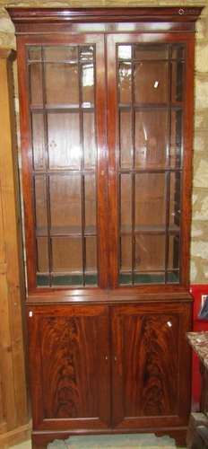 A Georgian mahogany library bookcase in two sections, the up...