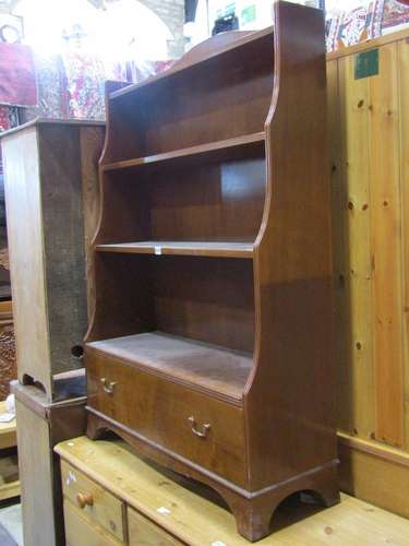 An open waterfall bookcase in the Georgian style with four s...