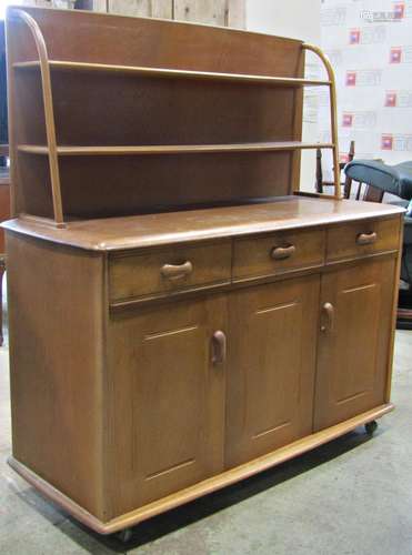 A Priory oak low cottage dresser enclosed by three doors one...