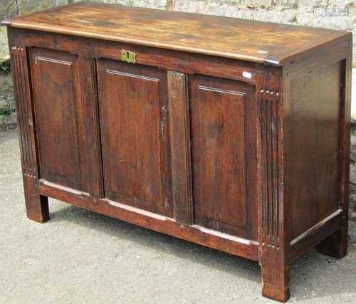 An oak coffer with hinged lid and panelled frame (constructe...