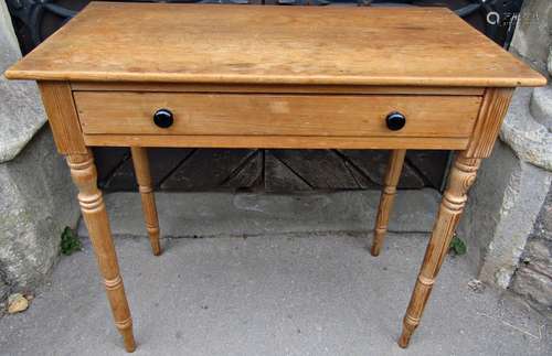 A stripped pine side table fitted with a shallow frieze draw...