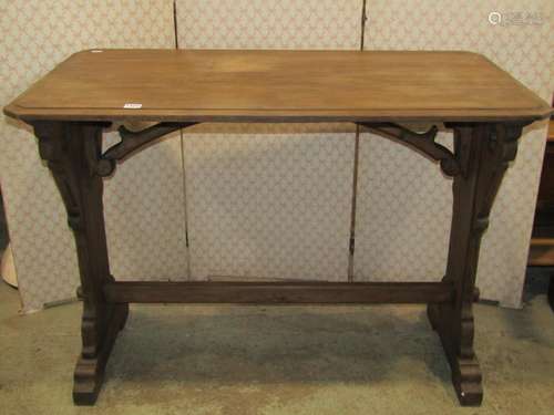 A stained pine gothic revival table, the rectangular top wit...