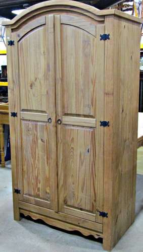 A contemporary stripped pine wardrobe, freestanding and encl...