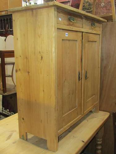 A stripped pine side cupboard freestanding and enclosed by a...