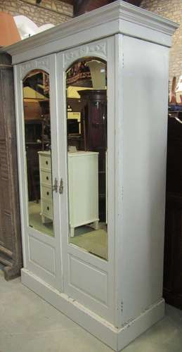 An Edwardian two sectional wardrobe with later painted finis...