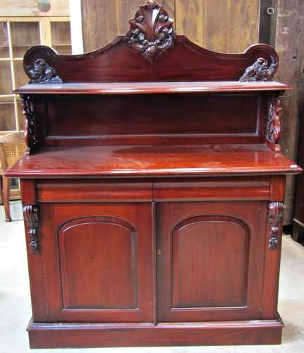 A reproduction hardwood chiffonier with raised shaped and mo...