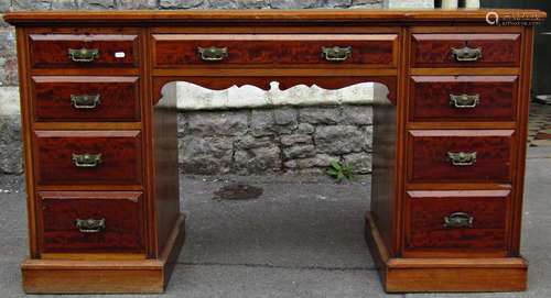 A late Victorian kneehole twin pedestal desk with inset sage...