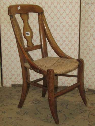 A 19th century childs/dolls size chair with vase shaped spla...