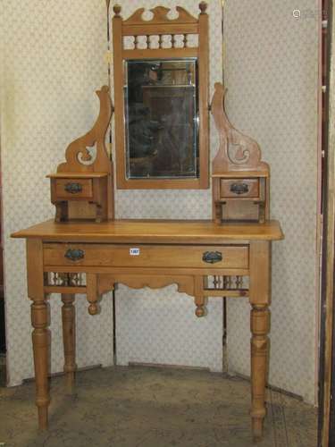 An Edwardian stripped and waxed pine dressing table, the rai...