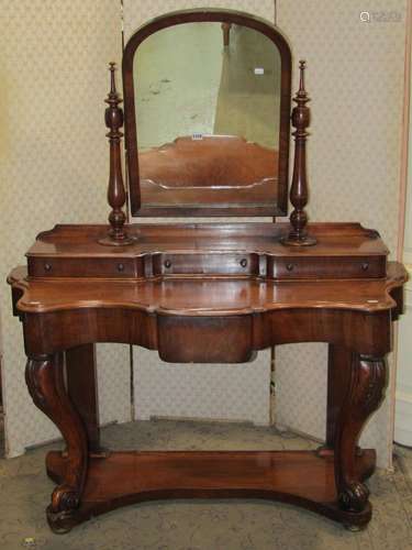 A Victorian mahogany duchess dressing table with raised arch...