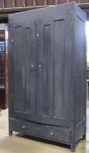 A vintage pine wardrobe enclosed by a pair of three quarter ...