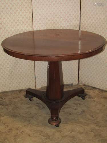 A simple Victorian mahogany table, the circular top raised o...