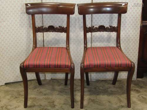 A pair of Regency mahogany side chairs with carved and shape...