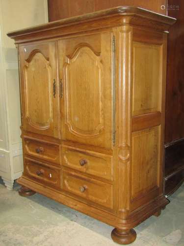 A substantial light oak side cupboard partially enclosed by ...