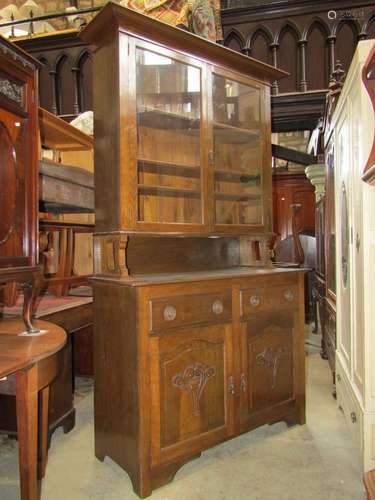 An Edwardian oak dresser, the upper section with projecting ...