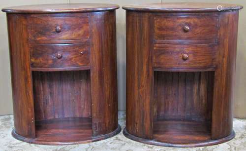 A pair of hardwood side/lamp tables of oval form each fitted...