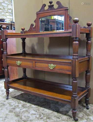 A late Victorian walnut three tier buffet with raised back i...