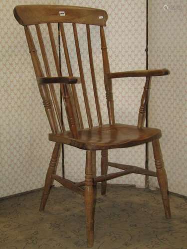 A Windsor stained elm and beechwood stick back open armchair...