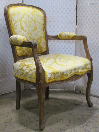 A salon chair with repeating floral patterned upholstered se...