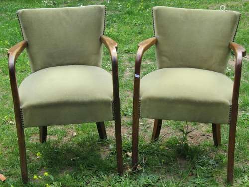 A pair of 1930s oak framed open armchairs, with sage green f...