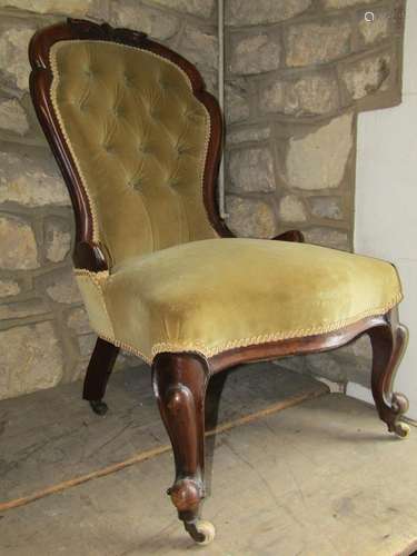 A Victorian ladies drawing room chair the upholstered seat w...