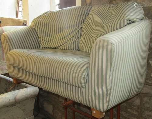 A two seat sofa with shaped outline and repeating green and ...