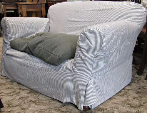 A Edwardian two seat sofa, with rolled arms, upholstered fin...