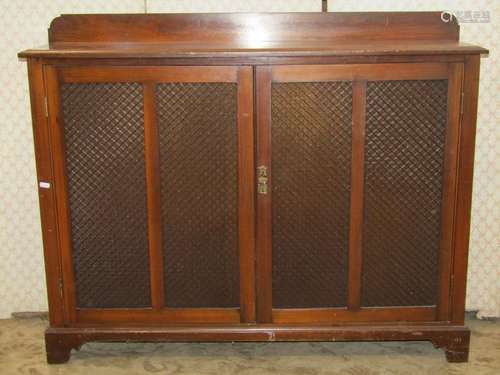 A narrow Edwardian walnut side cupboard in the Georgian styl...