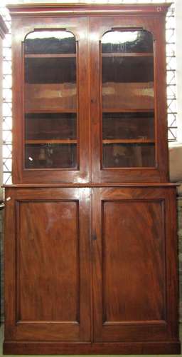 A Victorian mahogany library bookcase, the lower section enc...