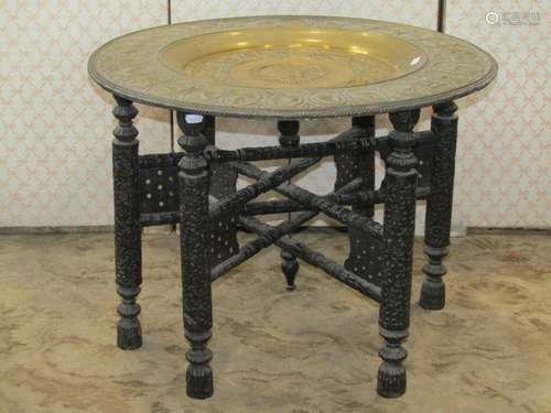 An Eastern embossed Benares type circular tray top occasiona...