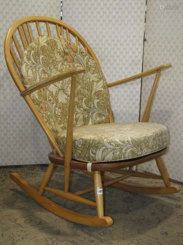 An Ercol rocking chair in a light colourway with stick back ...