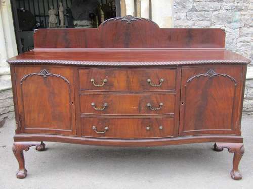 An Edwardian mahogany dining room set, the sideboard of serp...