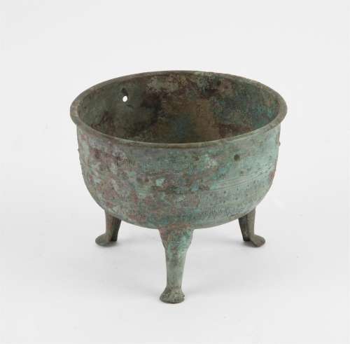 Chinese archaic style bronze tripod ding. The body decorated...