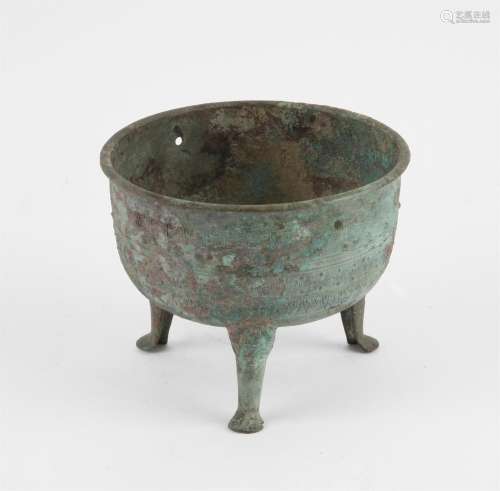Chinese archaic style bronze tripod ding. The body decorated...