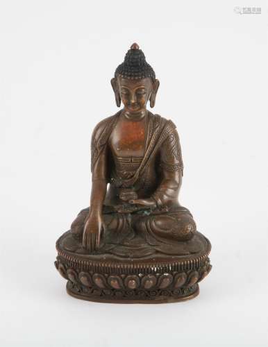 A Tibetan sitting bronze Buddha. Seated in Dhyanasana, holdi...