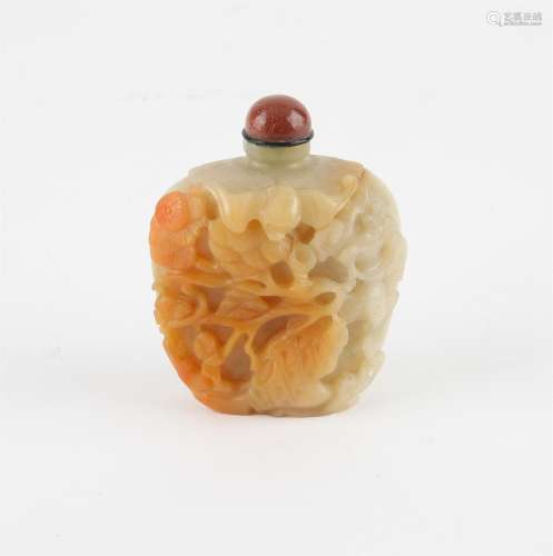 A Chinese pale greenish and russet jade snuff bottle. Finely...